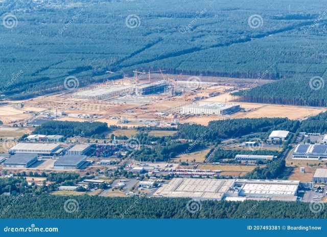 Tesla Gigafactory Berlin Brandenburg Construction Protesters holding signs and blocking a road near a forested area in Brandenburg, Germany, opposing Tesla's planned factory construction.