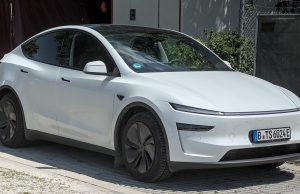 Tesla Launches Robotaxi Service in Austin A Tesla vehicle with Full Self-Driving software drives through Austin streets with a safety monitor in the front passenger seat.