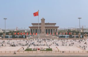 China Extends Holiday as Coronavirus Death Toll Hits 82 Chinese workers in face masks walk through a nearly empty city street during the coronavirus outbreak.