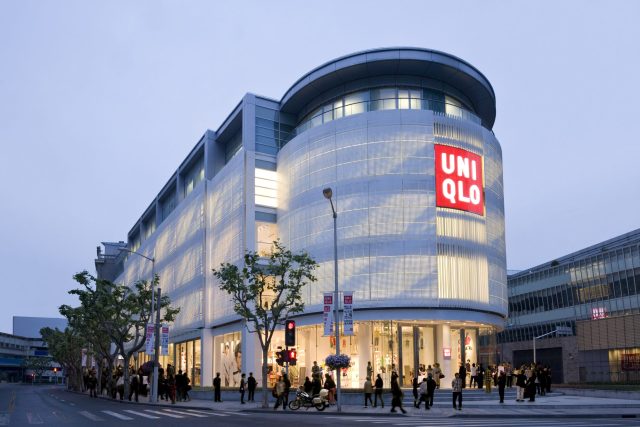 Uniqlo Store Reopening China 2020 Customers wearing masks stand in line at a Uniqlo store in Shanghai with social distancing markers on the floor.