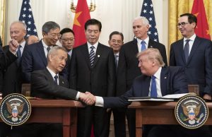 US, China Sign Phase 1 Trade Deal, Resume Talks US Treasury Secretary Steven Mnuchin and China's Vice Premier Liu He shaking hands at a signing ceremony in Washington, DC.