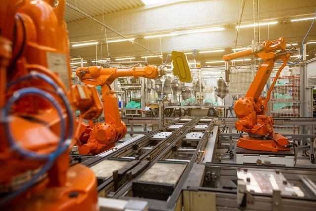 Google DeepMind restricts new robotics models to four trusted partners A robotic arm with a gripper approaches a cup on a table, demonstrating embodied reasoning in a controlled testing environment.