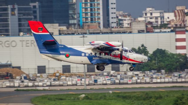 Pentagon Report Reveals Russian Jet Landing at Iraq Base with U.S. Troops A military surveillance aircraft flies over a desert airbase with runway lights visible below.