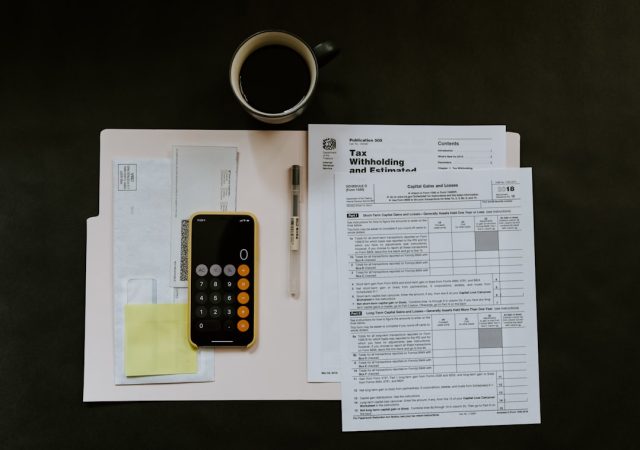 Malaysian fund managers told to prepare for tax exemption expiry by 2022 Fund managers reviewing documents at a desk in Kuala Lumpur, preparing for the tax exemption expiry deadline.