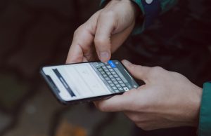 Apple iOS 26 Unveils Liquid Glass Design Overhaul Apple iOS 26 Liquid Glass interface on an iPhone, showing glossy transparent icons and fluid motion.