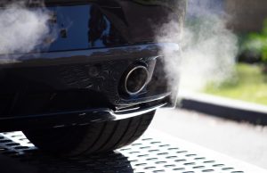 Rhode Island Emissions Leap 8.2%, Miss 2020 Climate Target Smoke rises from a natural gas plant against a hazy sky, symbolizing rising CO₂ emissions in Rhode Island.