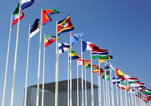 UN General Assembly faces arithmetic challenge on Russia rights council vote U.S. diplomats huddle at UNGA desks counting yellow vote cards while Russian seat sits empty in Geneva council chamber.