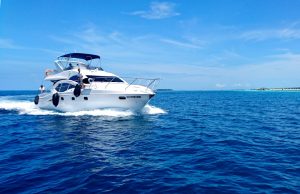40 Haitian Migrants Die in Boat Fire Near Turks and Caicos A burning migrant vessel at sea near the Turks and Caicos Islands, with rescue boats approaching the smoke-filled scene.
