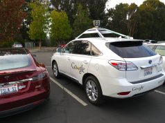 Waymo Robotaxis Hit 500,000 Weekly Paid Rides A Waymo autonomous vehicle drives on a city street with passengers inside