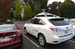 Waymo Robotaxis Hit 500,000 Weekly Paid Rides A Waymo autonomous vehicle drives on a city street with passengers inside